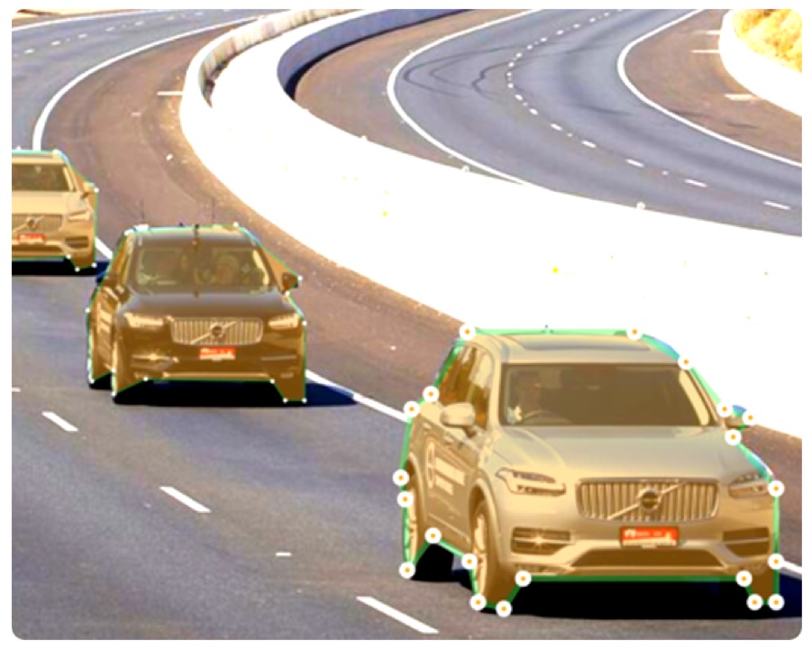 Polygon annotation tracing the exact outline of vehicles on a curved road
